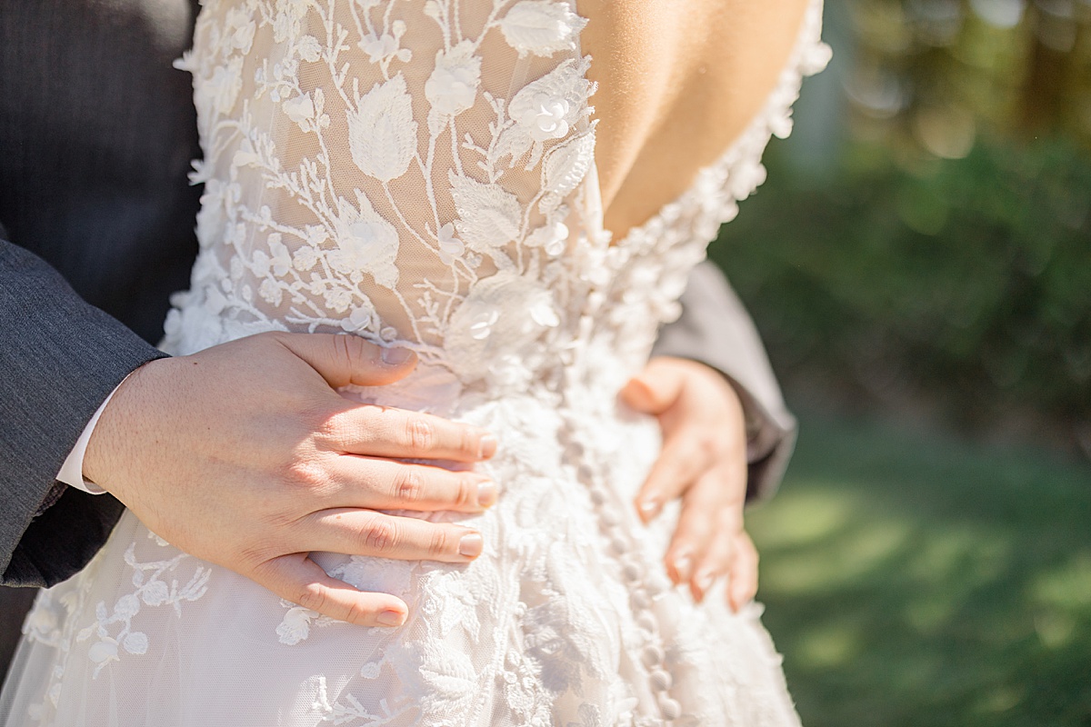 detail of bride's embroidered tulle gown with floral motif shot by Hunter Hennes Photography