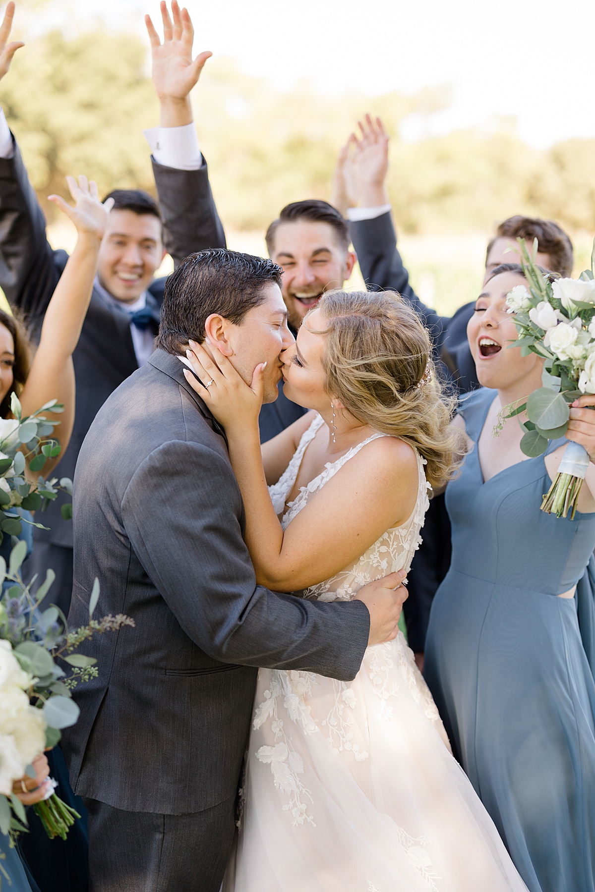 wedding party celebrates as bride and groom kiss at california wedding shot by Hunter Hennes Photography