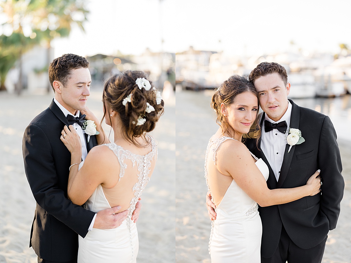 bride with white flowers in her hair adjusts groom's bowtie before vow renewal at huntington beach