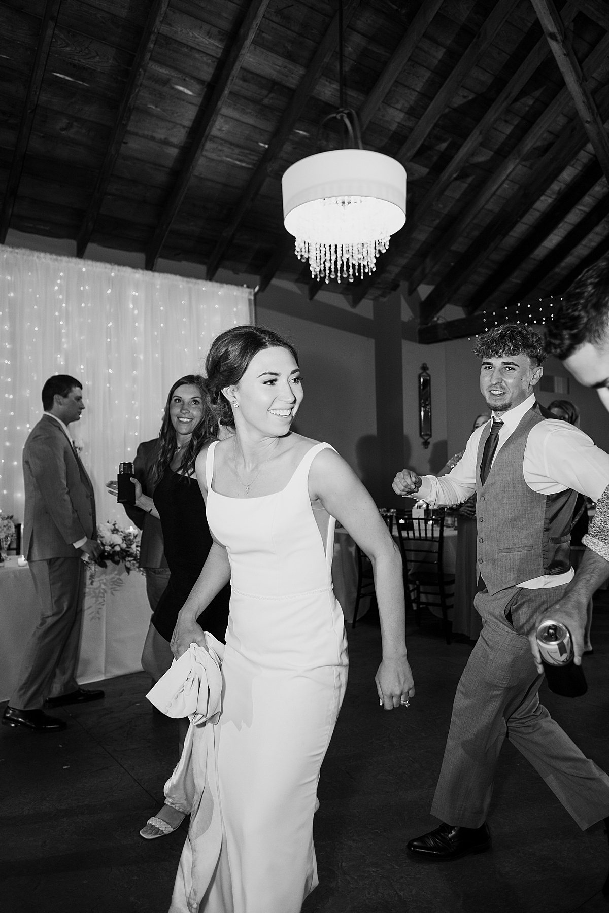 bride celebrates with wedding guests at fun reception shot by destination wedding photographer