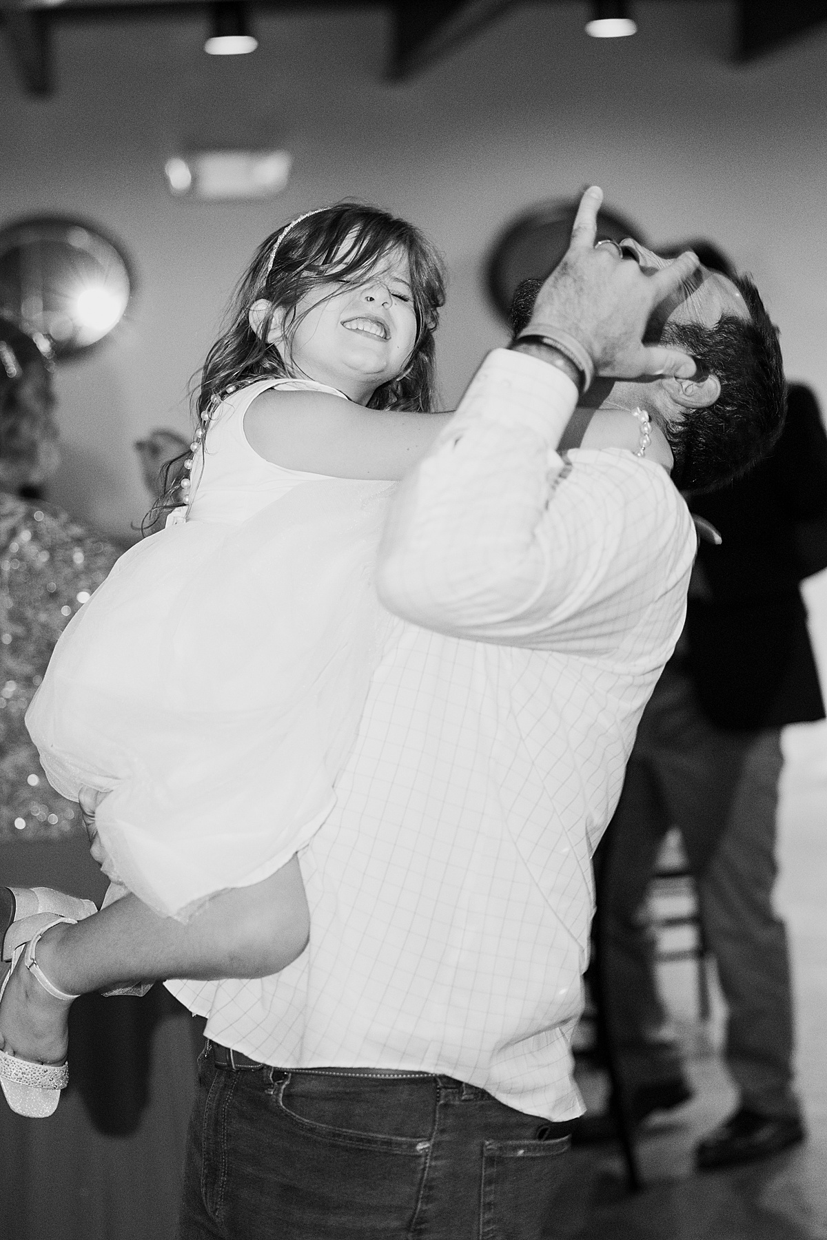 wedding guest and daughter jam to dance tunes at celebratory reception shot by destination wedding photographer