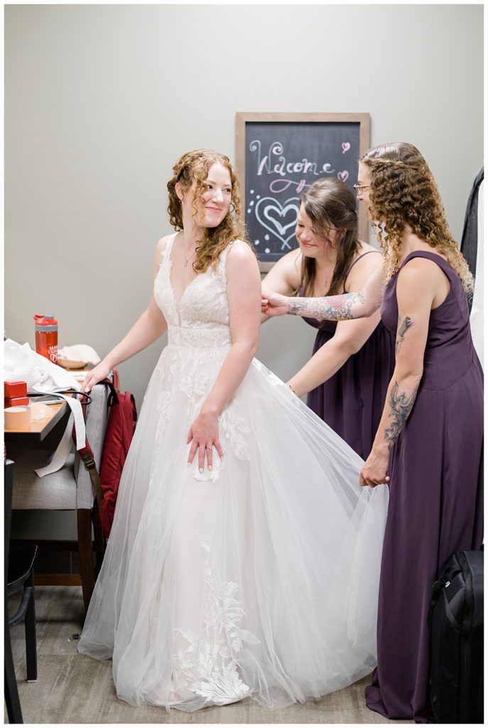 bridesmaids zip dress while bride looks back at them by destination wedding photographer