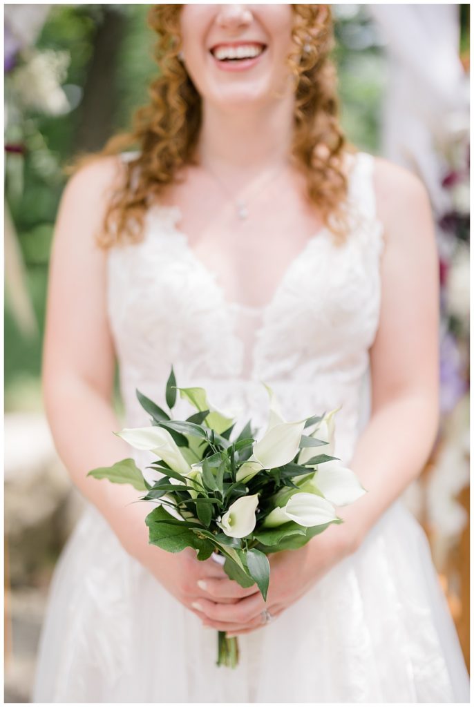 bride holds small bouquet by destination wedding photographer
