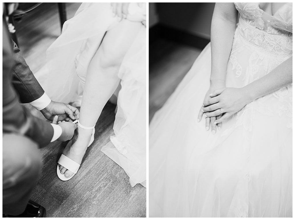 man puts on bride's shoe and bride holds hands over dress by Hunter Hennes Photography 