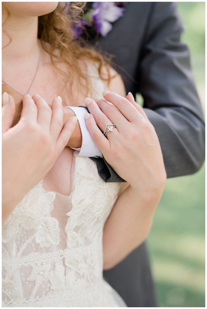 groom puts arm around bride and she holds him by Hunter Hennes Photography 
