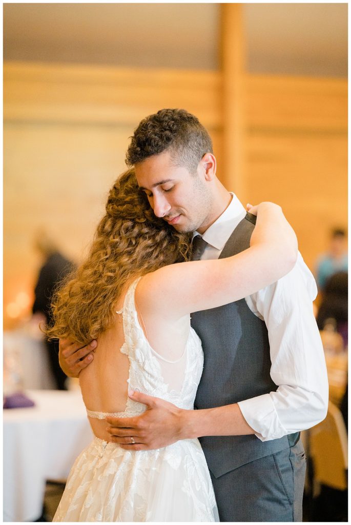 bride rests head on groom while they dance at Minnesota park wedding