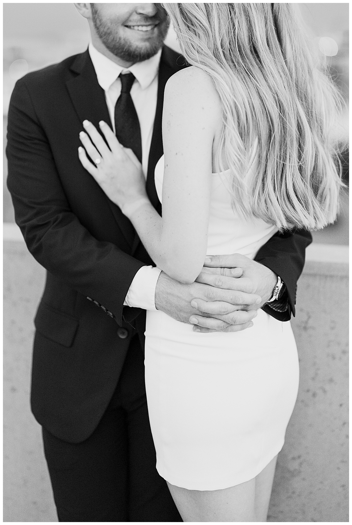 man holds woman around waist by destination wedding photographer