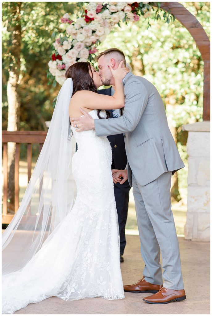 couple kisses in wedding attire by Hunter Hennes Photography
