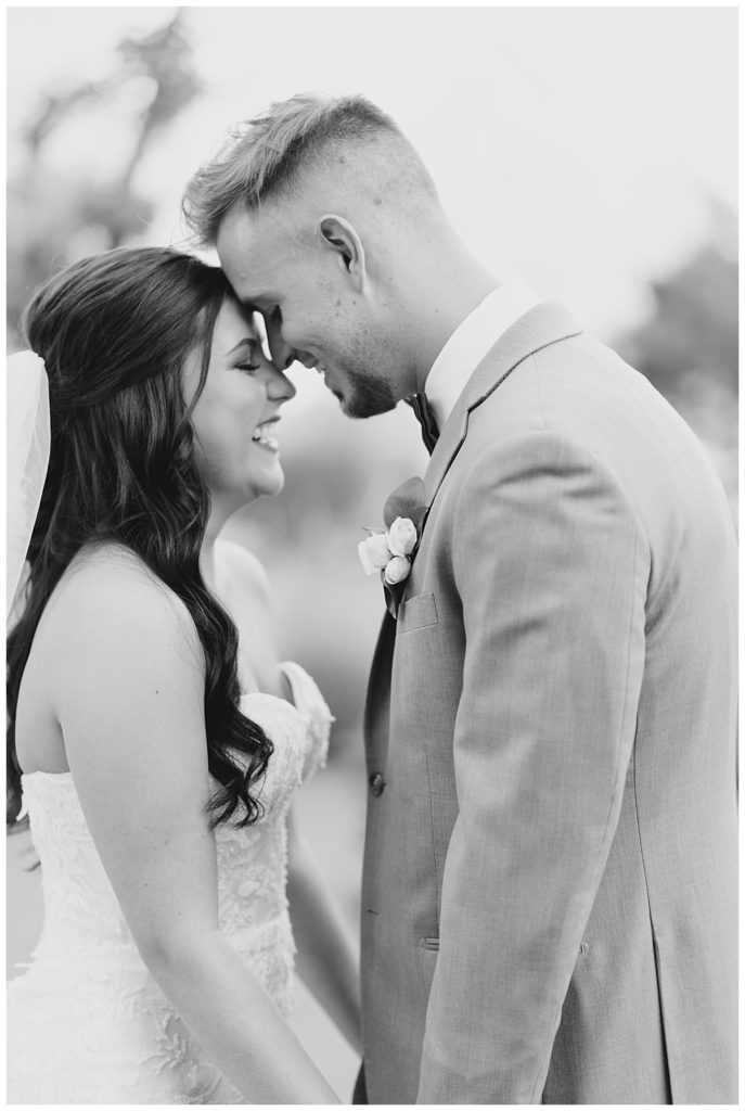 man and woman touch foreheads at elegant Oklahoma wedding