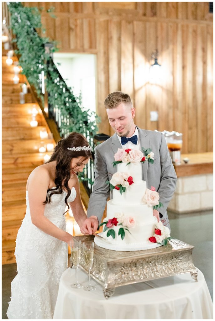 bride and groom cut cake at elegant Oklahoma wedding