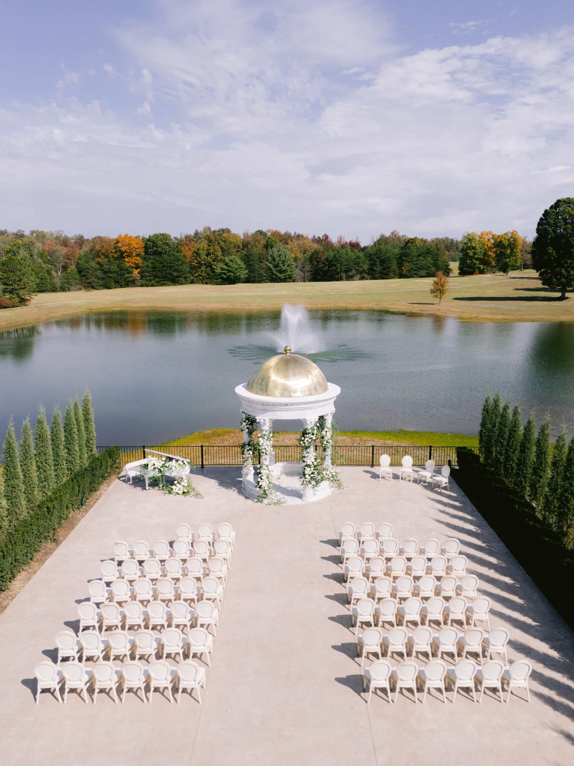 drone photo of the ceremony space with white gazebo and chairs.