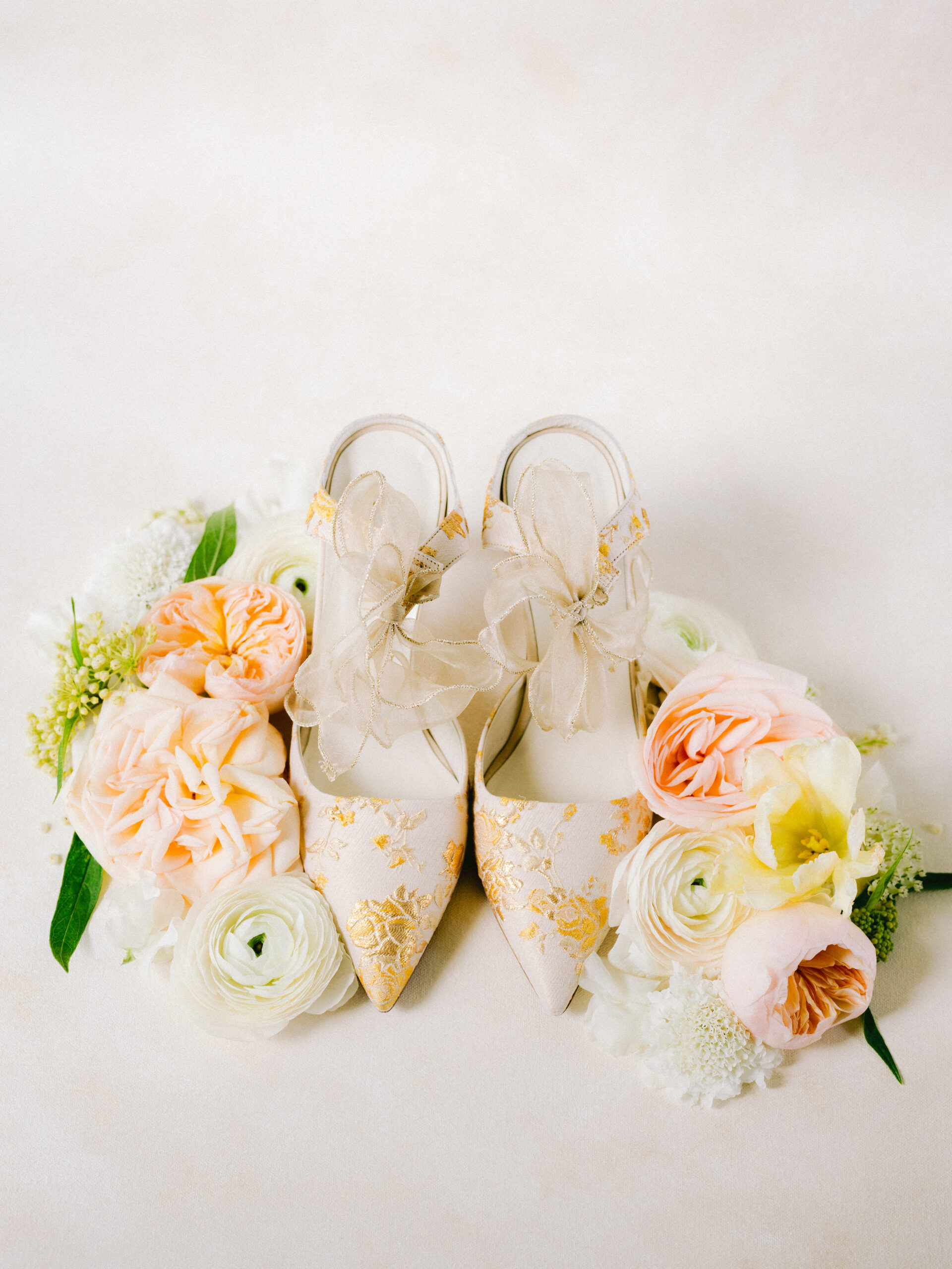 wedding shoes surrounded by flowers