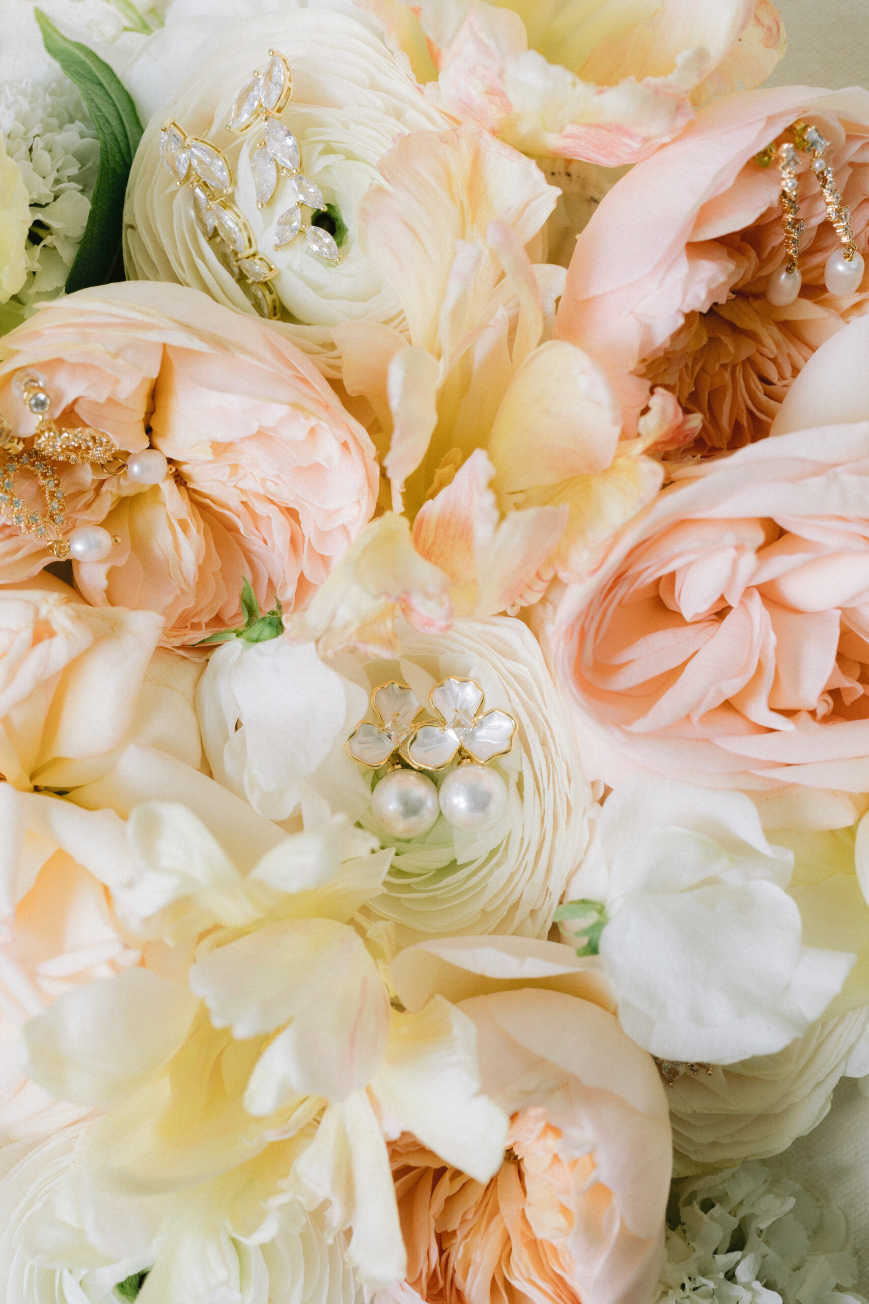 close up of wedding earrings on flowers